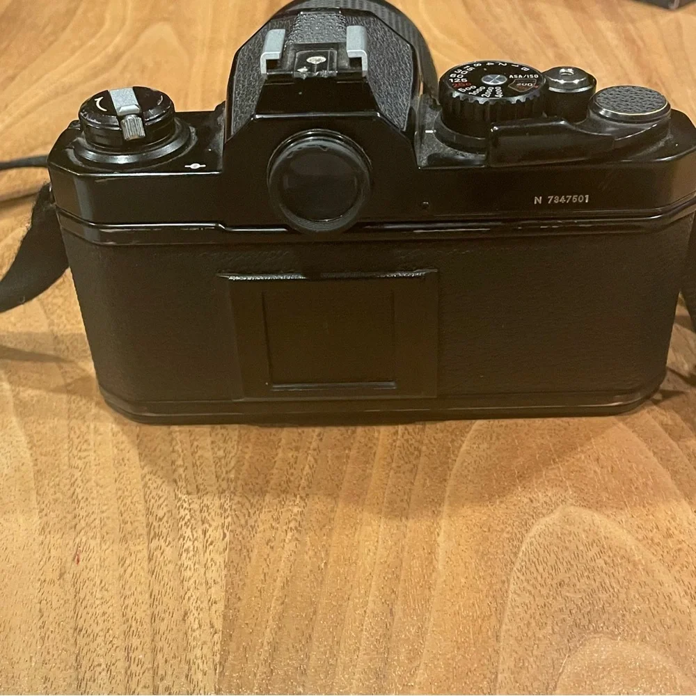 Vintage Nikon FM2 black camera with lens